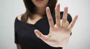 Young Woman Showing Her Denial With No On Her Hand